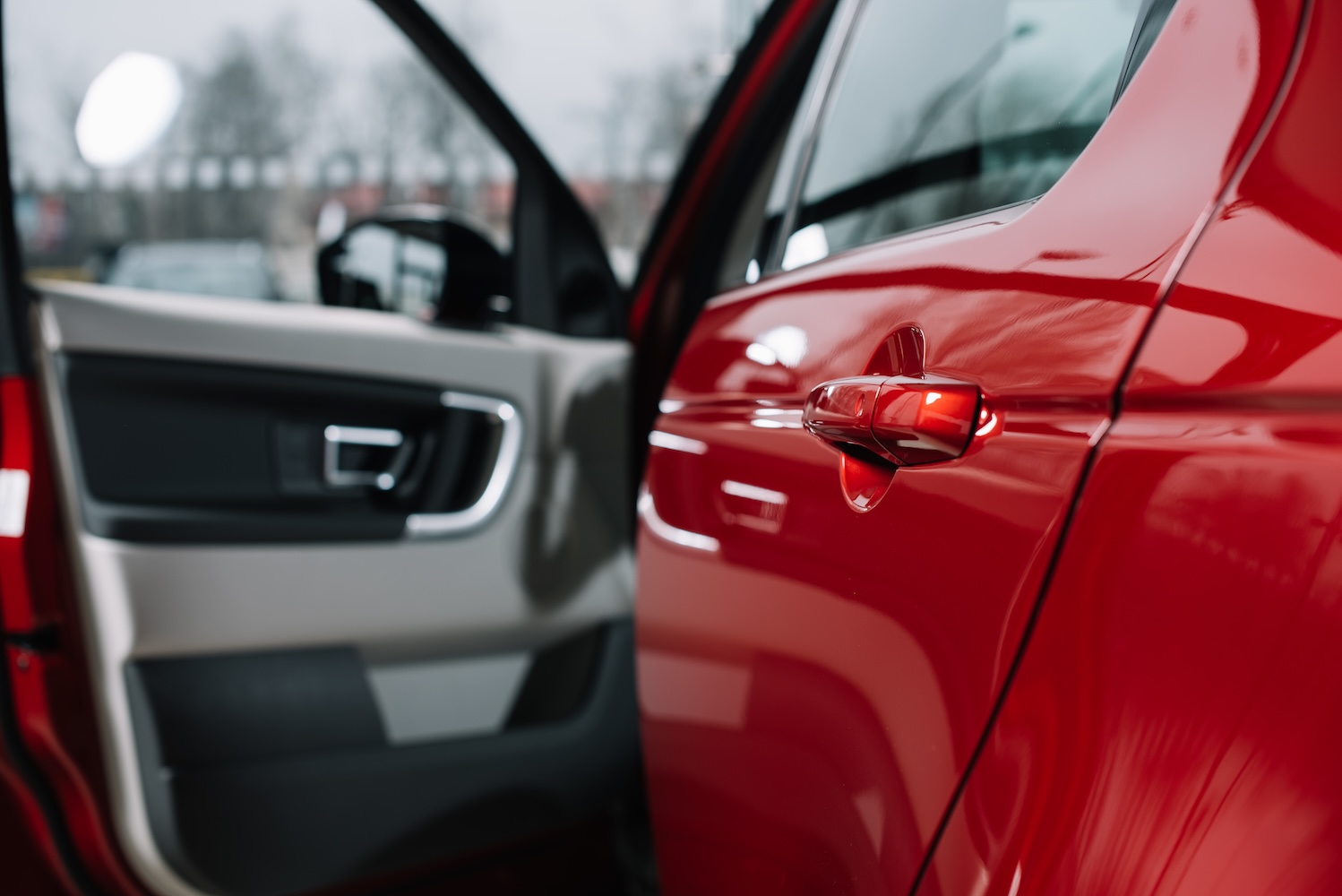 Open Car Door On A Shiny Red Vehicle