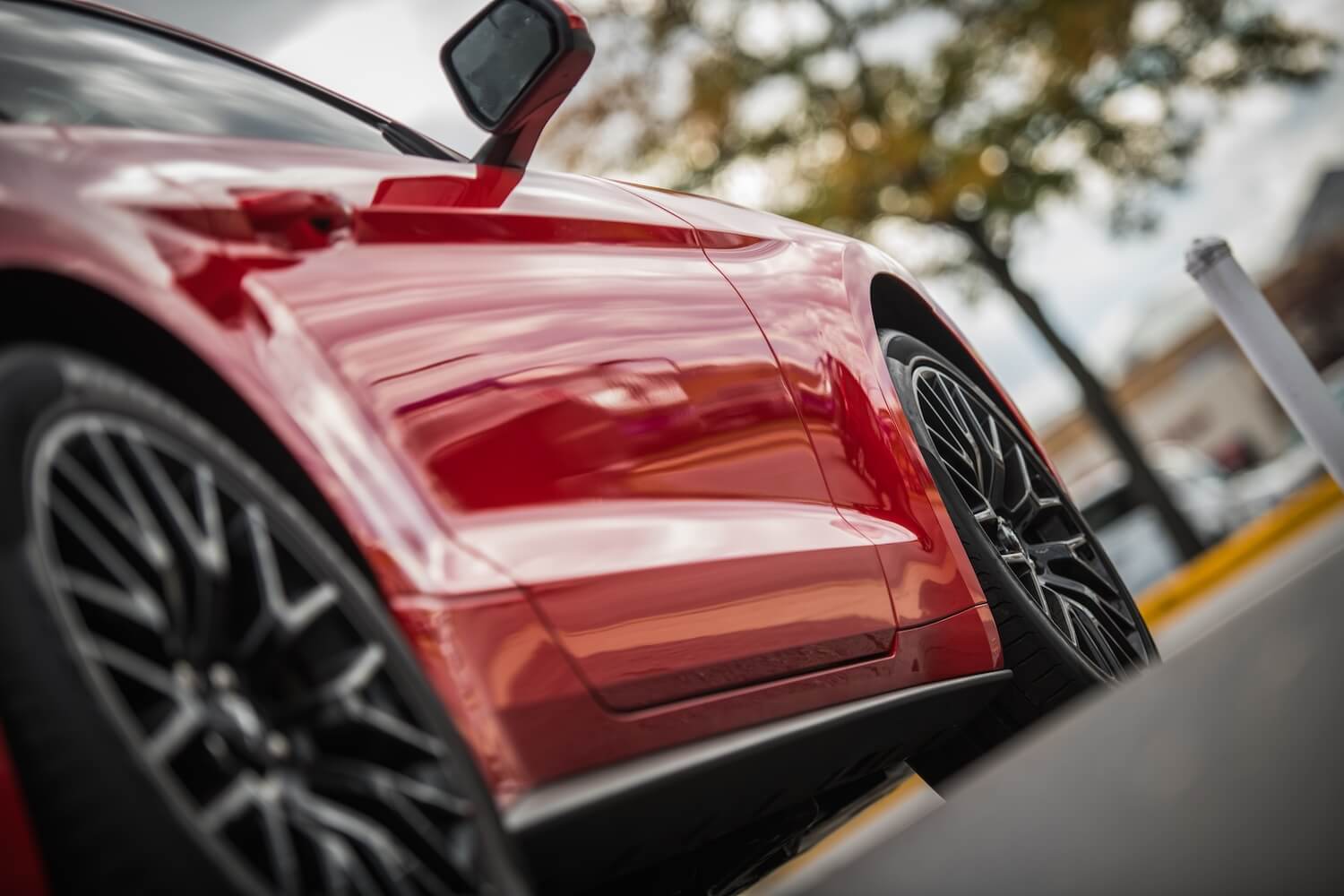 Sleek Red Car Detail In Urban Setting